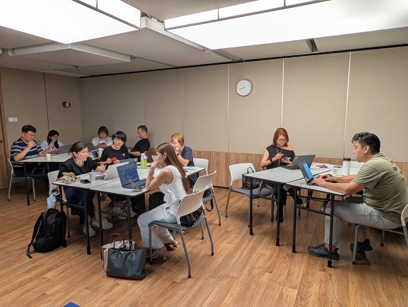 Participants working around tables during the workshop.